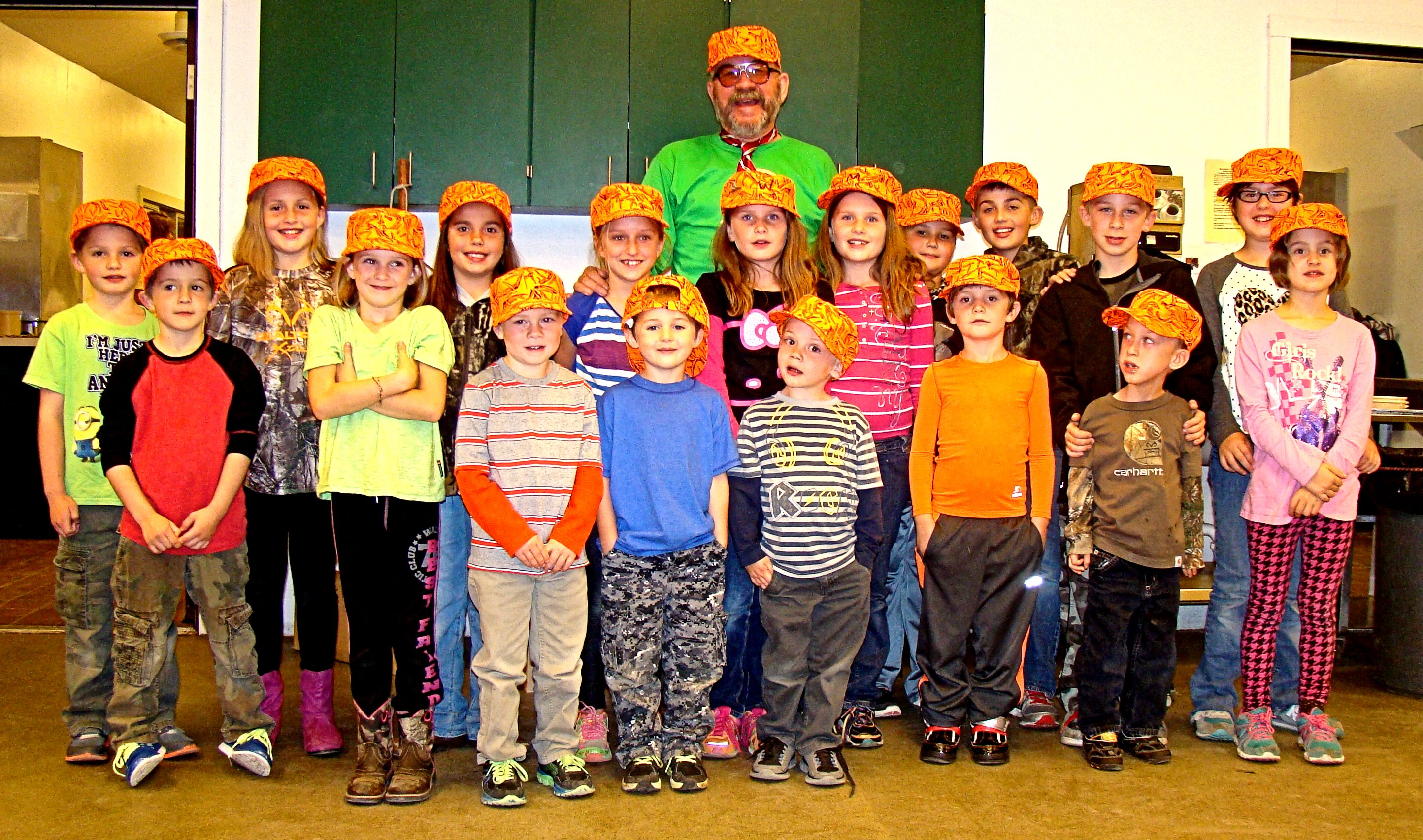 Here is one good looking bunch or the "Little People" who attended this year's UFFDA Hunt wearing their special UFFDA hats and surrounding the biggest kid at the hunt.